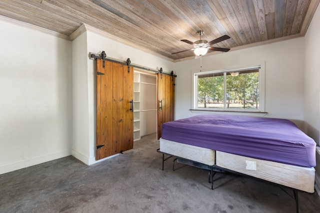 bedroom featuring ceiling fan, crown molding, wood ceiling, and a barn door