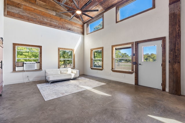 unfurnished room with high vaulted ceiling, a healthy amount of sunlight, cooling unit, and ceiling fan