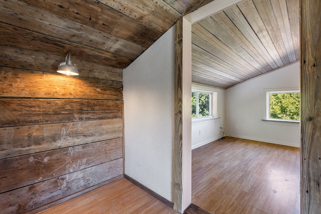 bonus room with wood ceiling, light wood-type flooring, and vaulted ceiling