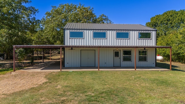 view of outbuilding with a yard and a carport