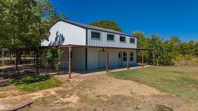 back of property with a yard, a patio, and ceiling fan