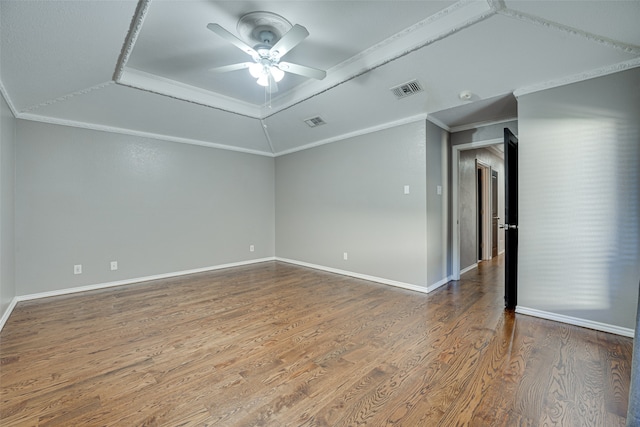 empty room with wood-type flooring, ceiling fan, and ornamental molding