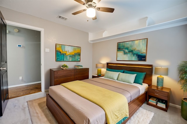 bedroom with ceiling fan and light hardwood / wood-style flooring