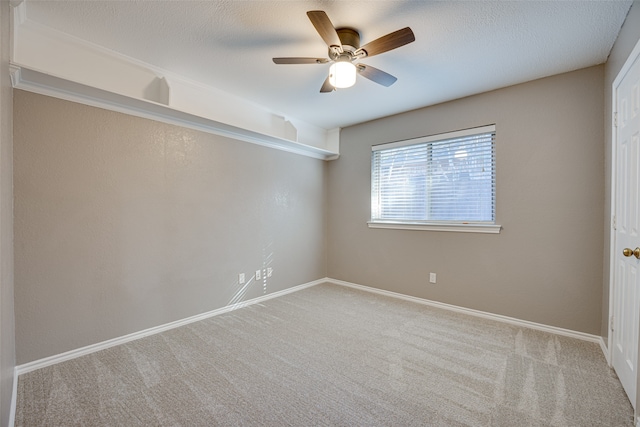 carpeted spare room with ceiling fan and a textured ceiling