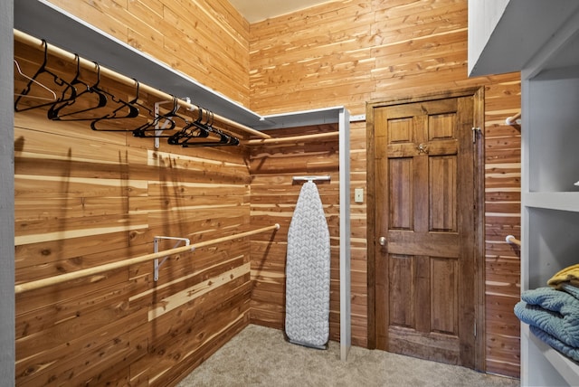 walk in closet with carpet floors