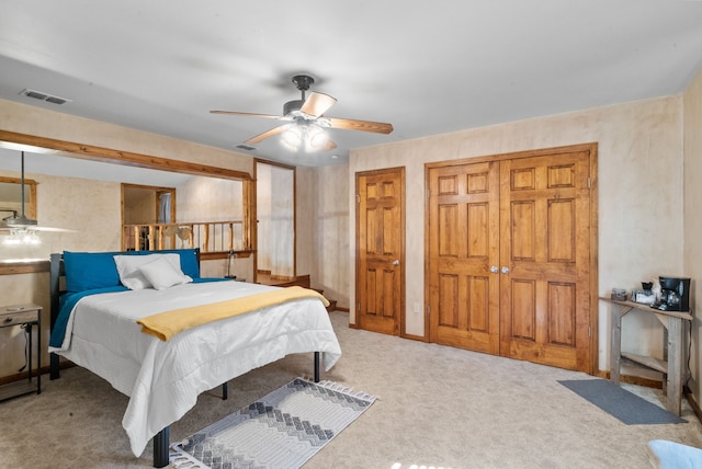 carpeted bedroom with two closets and ceiling fan