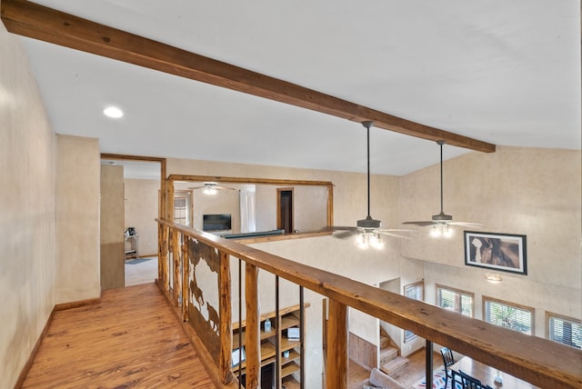 hall with lofted ceiling with beams and light hardwood / wood-style flooring