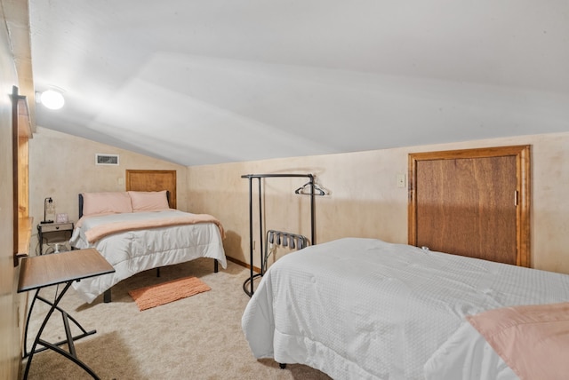 carpeted bedroom with vaulted ceiling