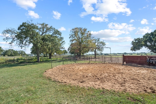 surrounding community featuring a lawn and a rural view