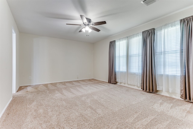 empty room with light colored carpet and ceiling fan