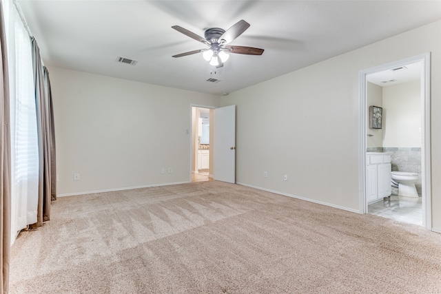 empty room with light colored carpet and ceiling fan