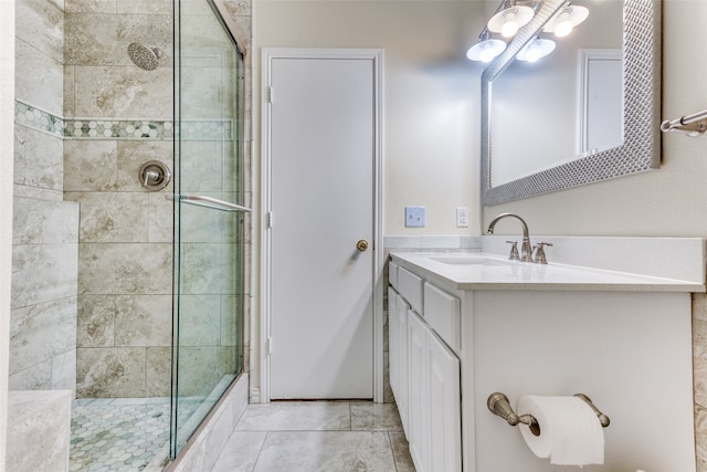 bathroom featuring vanity and an enclosed shower