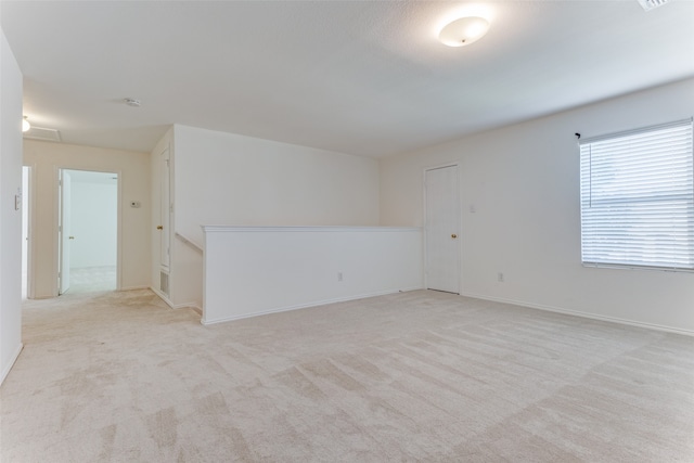 spare room with light colored carpet