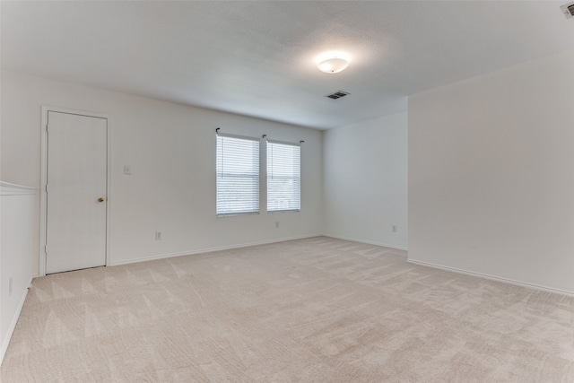 unfurnished room with light colored carpet