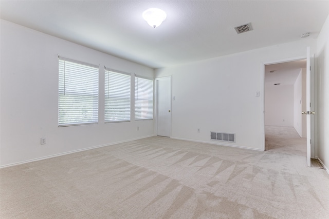 empty room featuring light carpet