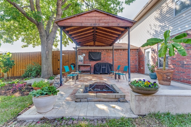 view of patio / terrace with area for grilling and a fire pit