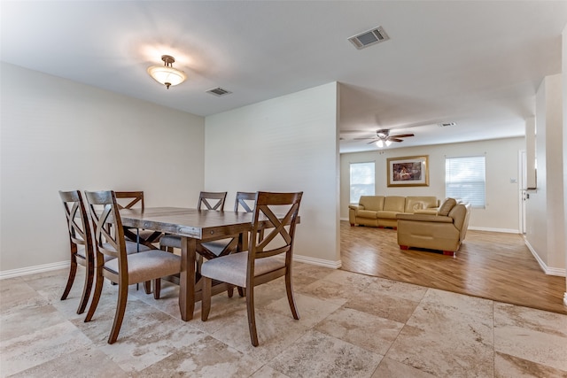 dining space with light hardwood / wood-style flooring and ceiling fan