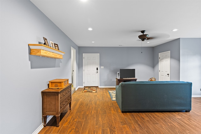 living room with wood-type flooring and ceiling fan