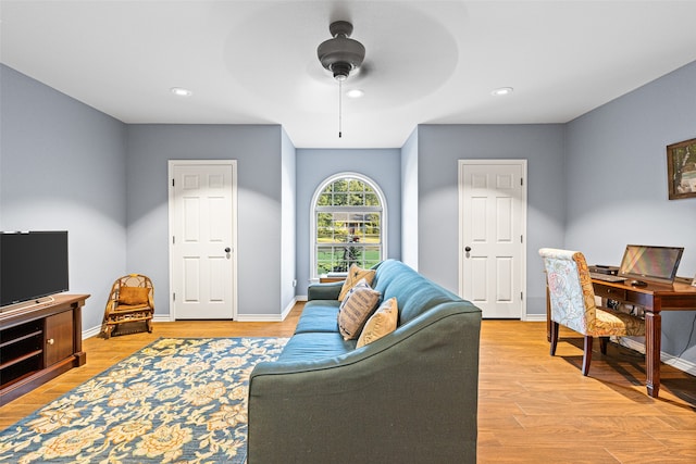 living room featuring light hardwood / wood-style floors and ceiling fan