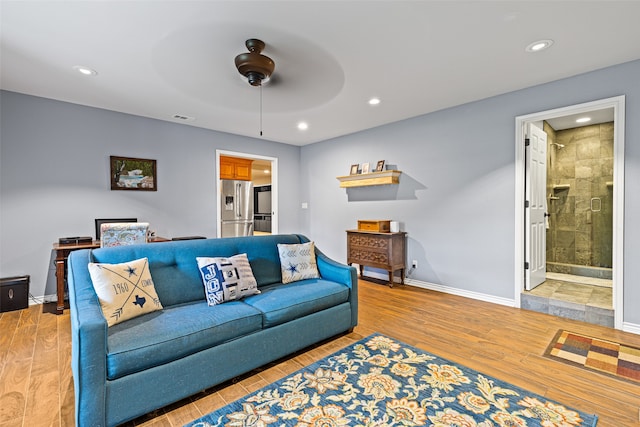 living room with hardwood / wood-style floors and ceiling fan