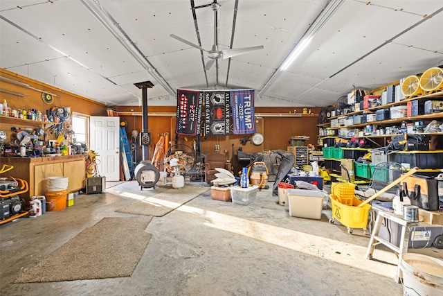 misc room with concrete floors, wood walls, a workshop area, and vaulted ceiling