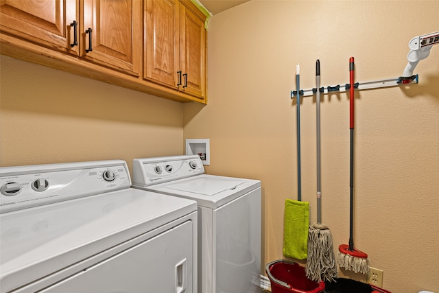 laundry area with cabinets and washing machine and dryer