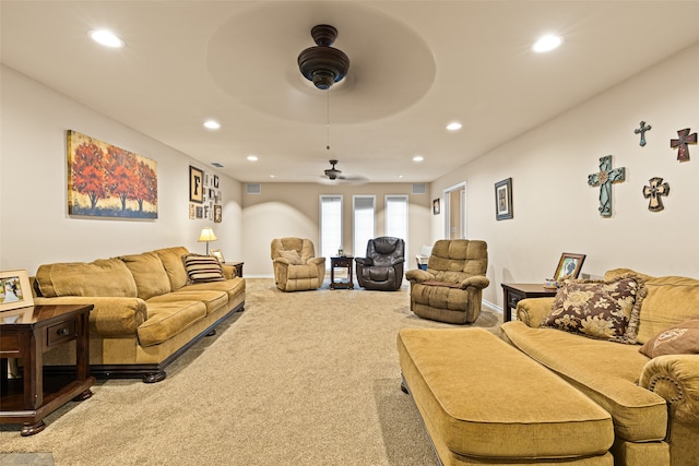 carpeted living room featuring ceiling fan