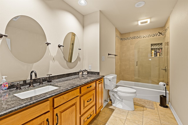 full bathroom with vanity, tiled shower / bath combo, toilet, and tile patterned floors