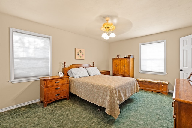 bedroom featuring dark colored carpet and ceiling fan