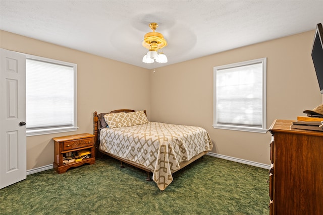 carpeted bedroom with a textured ceiling and ceiling fan