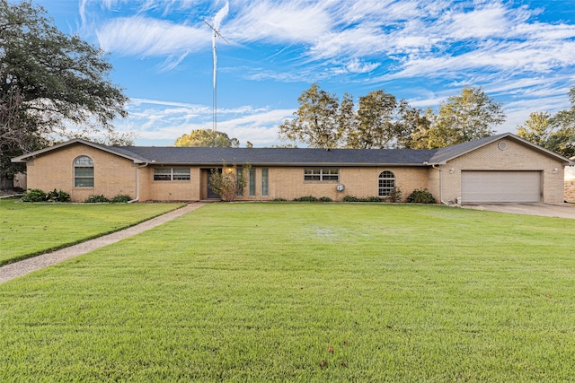 ranch-style house with a front yard and a garage