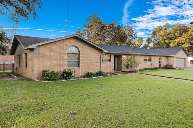 single story home featuring a front yard and a garage