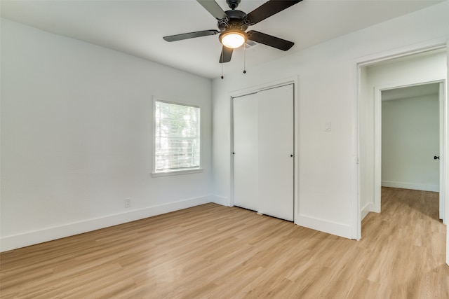 unfurnished bedroom with light hardwood / wood-style flooring, a closet, and ceiling fan