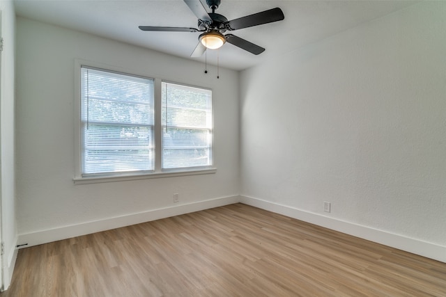 empty room with light wood-type flooring and ceiling fan