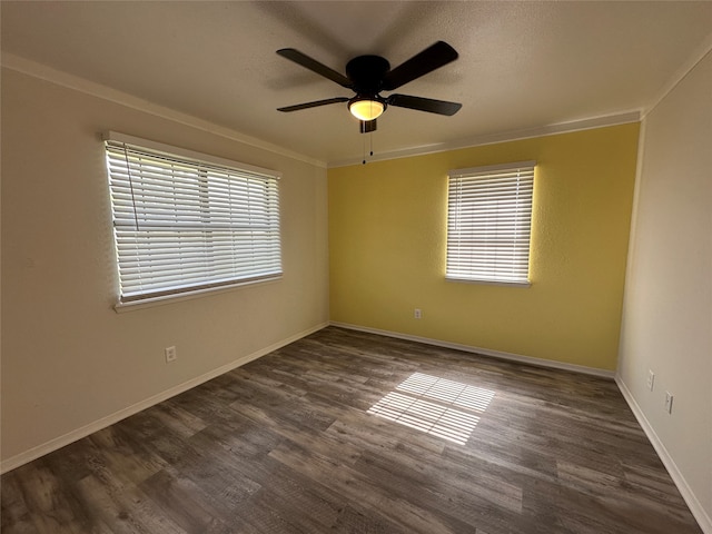 unfurnished room featuring a healthy amount of sunlight, ornamental molding, and dark hardwood / wood-style floors