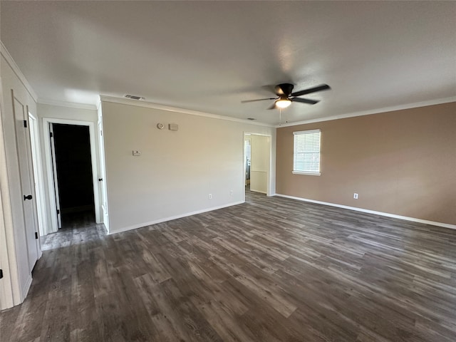 empty room featuring dark wood-type flooring, ceiling fan, and ornamental molding