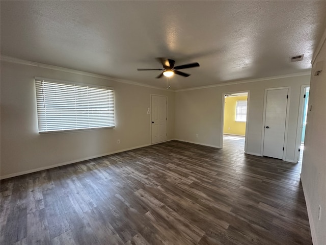 empty room with a textured ceiling, crown molding, dark hardwood / wood-style floors, and ceiling fan