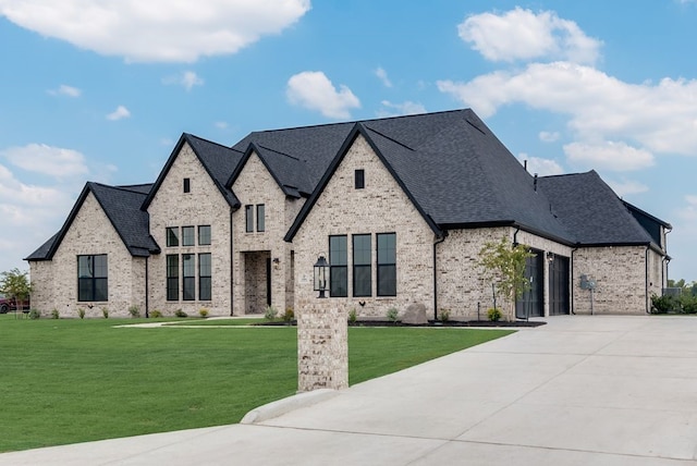 french country style house featuring a front yard