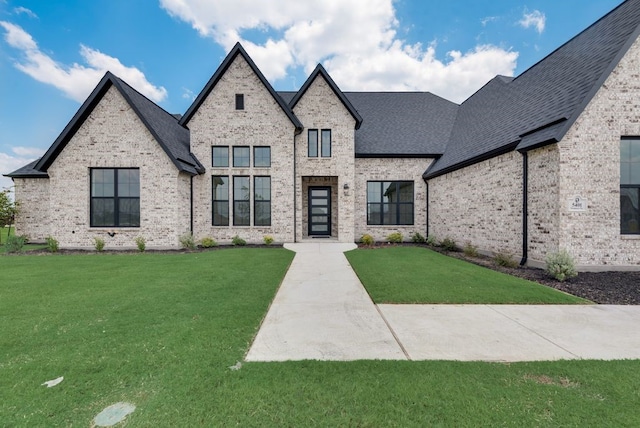 french country style house with a front yard