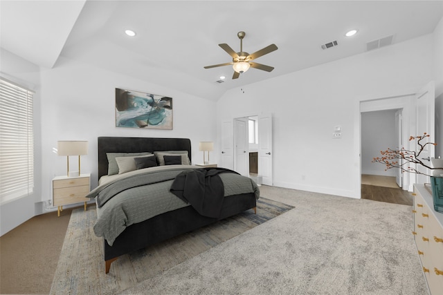 carpeted bedroom with ceiling fan and vaulted ceiling