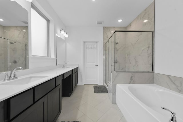 bathroom featuring tile patterned floors, vanity, and shower with separate bathtub