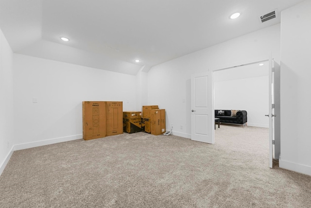 carpeted spare room featuring lofted ceiling