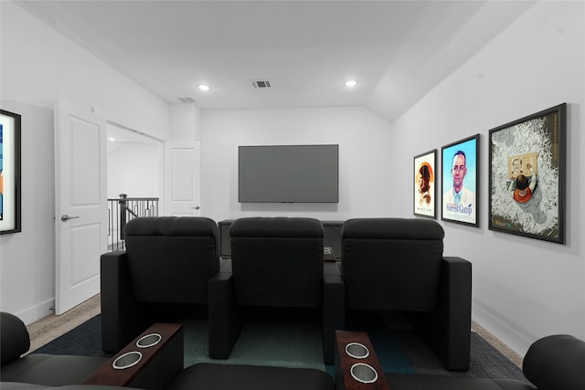 carpeted home theater featuring lofted ceiling