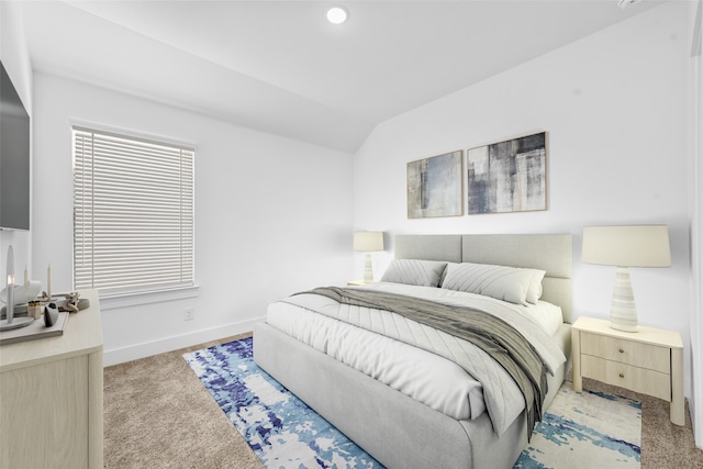 bedroom featuring light colored carpet and lofted ceiling