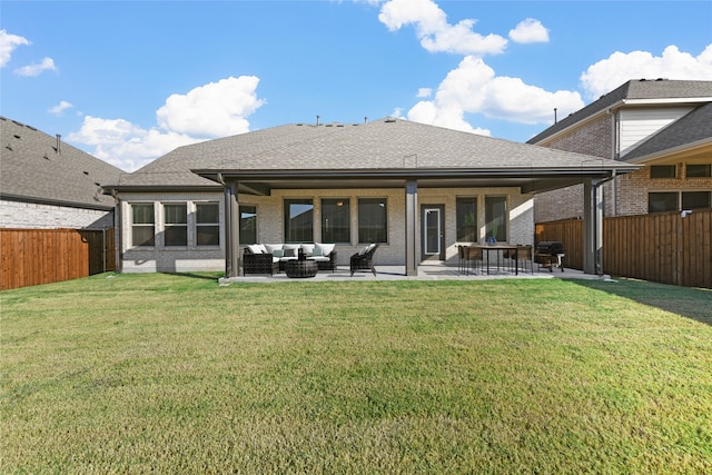 back of property featuring a lawn, a patio area, and an outdoor hangout area