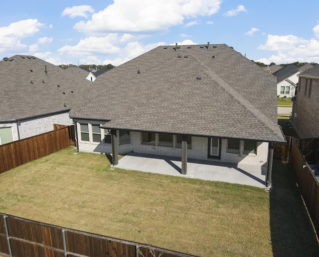 back of house with a yard and a patio area