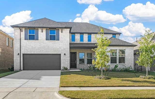 view of front facade with a front lawn and a garage