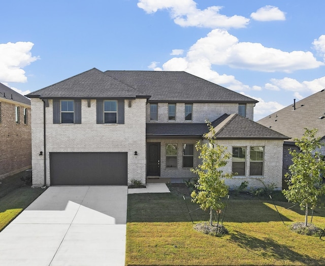 view of front of property featuring a front lawn and a garage