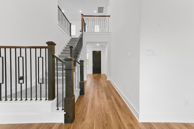 stairway with hardwood / wood-style flooring