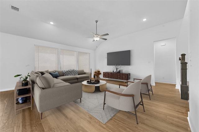 living room featuring light wood-type flooring, ceiling fan, and lofted ceiling